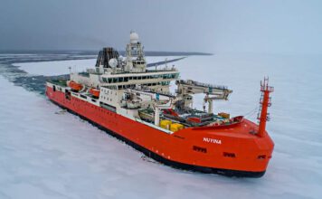 A red icebreaker ship cuts a swathe through ice RSV Nuyina is the Australian Antarctic Program's platform for supporting marine and atmospheric science Photo: Pete Harmsen